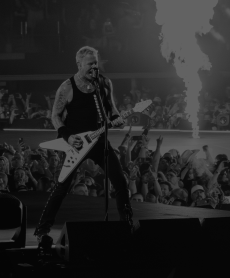 James Hetfield of Metallica plays guitar on stage in Arlington, TX in black and white.