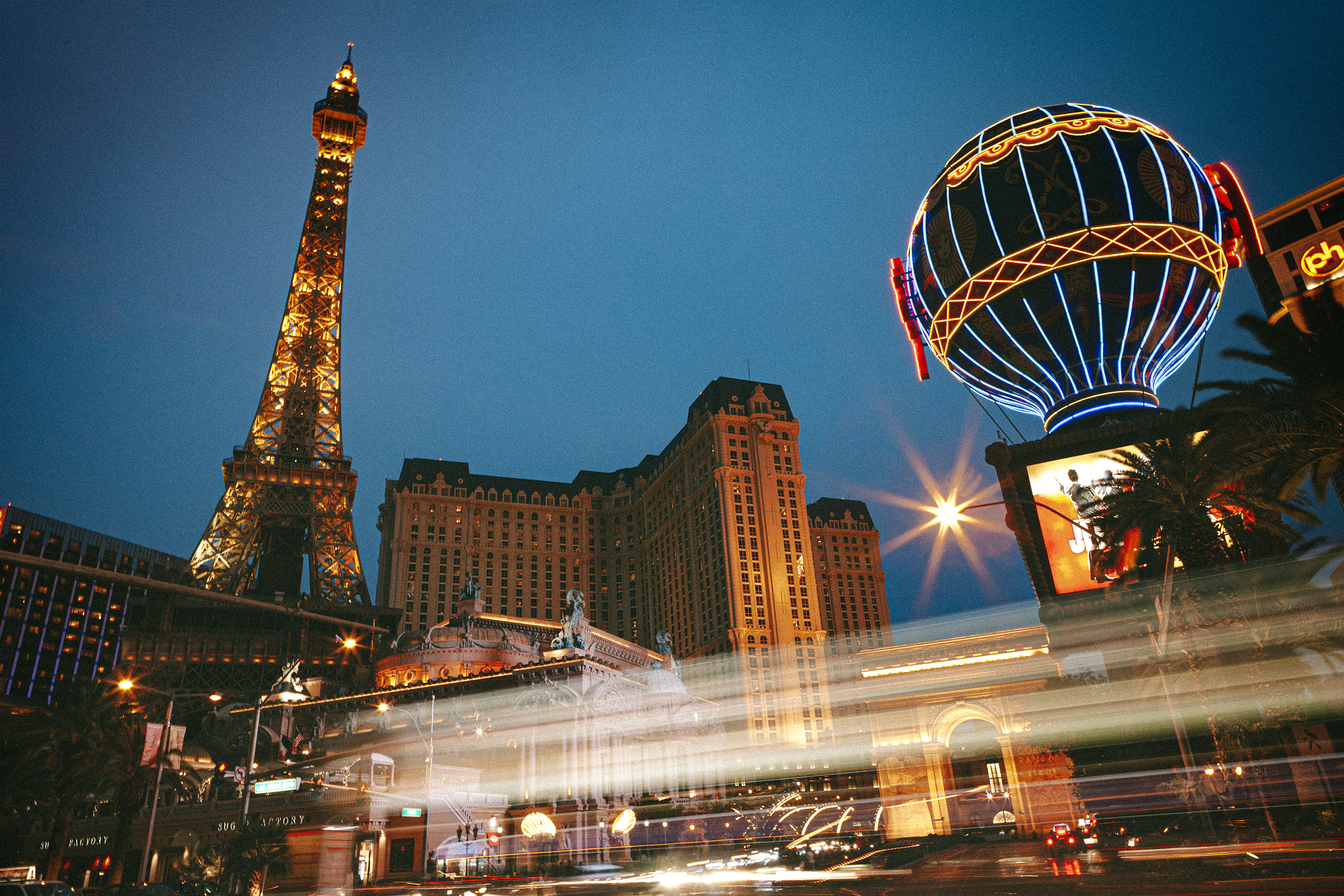 A long exposure of car light trails in front of the Paris hotel in Las Vegas, NV.