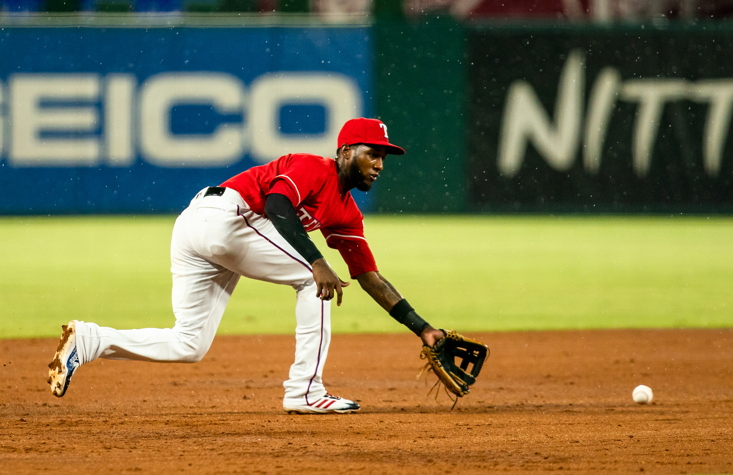 Jurickson Profar of the Texas Rangers fields an infield at Globe Life Park in the rain.